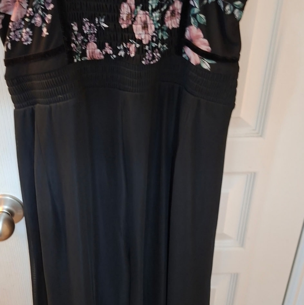 This is a Torrid black floral wide leg challis jumpsuit with a mesh overlay on t - Picture 2 of 5